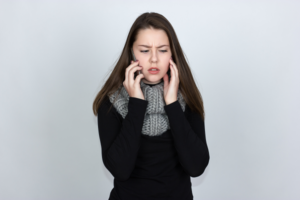 a woman on the phone with tooth pain