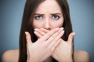 a concerned woman covering her mouth