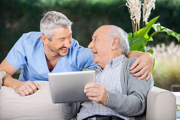 two men looking at a tablet together